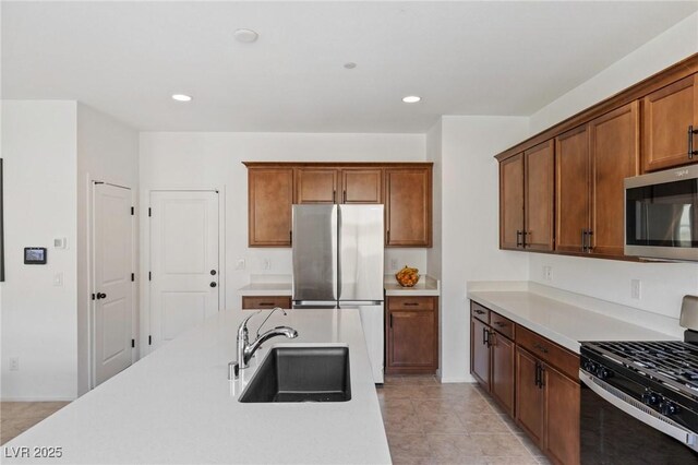10376 Sadie Blake Ave, Las Vegas, NV 89166 - kitchen featuring stainless steel appliances, a sink, light countertops, light tile patterned floors, and recessed lighting