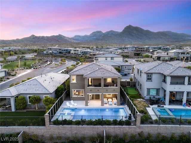 390 Coastal Redwood St, Las Vegas, NV 89138 - back of property at dusk with a balcony, a fenced backyard, and a residential view