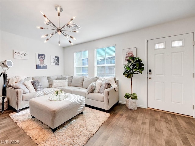 1125 Meadow Sparrow Pl, Henderson, NV 89011 - living room with a chandelier, light wood-type flooring, and baseboards