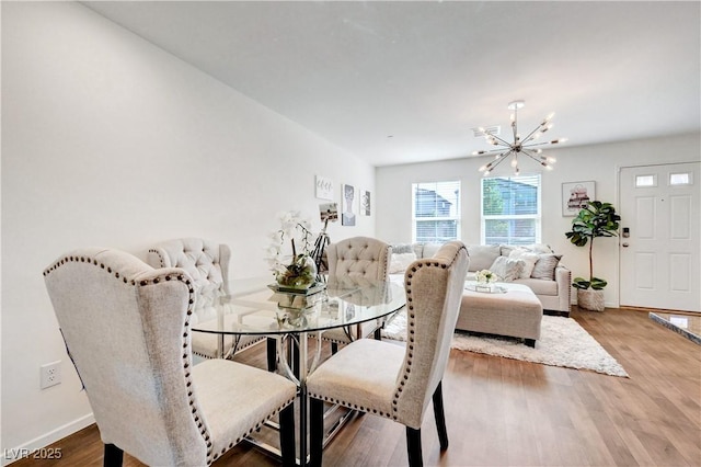 1125 Meadow Sparrow Pl, Henderson, NV 89011 - dining room with a chandelier, baseboards, and wood finished floors
