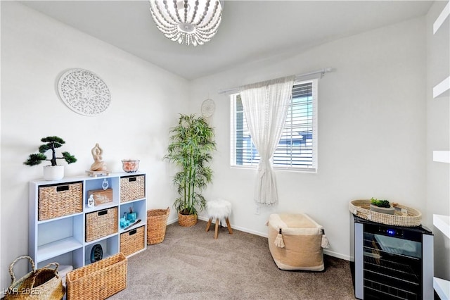 1125 Meadow Sparrow Pl, Henderson, NV 89011 - sitting room featuring a chandelier, carpet flooring, wine cooler, and baseboards