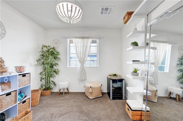 1125 Meadow Sparrow Pl, Henderson, NV 89011 - living area featuring carpet, a chandelier, wine cooler, and baseboards
