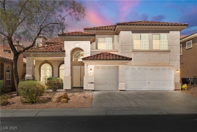 4607 El Camino Cabos Dr, Las Vegas, NV 89147 - mediterranean / spanish-style house with a tiled roof, driveway, stucco siding, and a garage