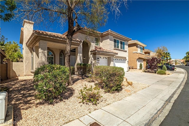 4607 El Camino Cabos Dr, Las Vegas, NV 89147 - mediterranean / spanish-style home with a chimney, concrete driveway, stucco siding, an attached garage, and a tile roof