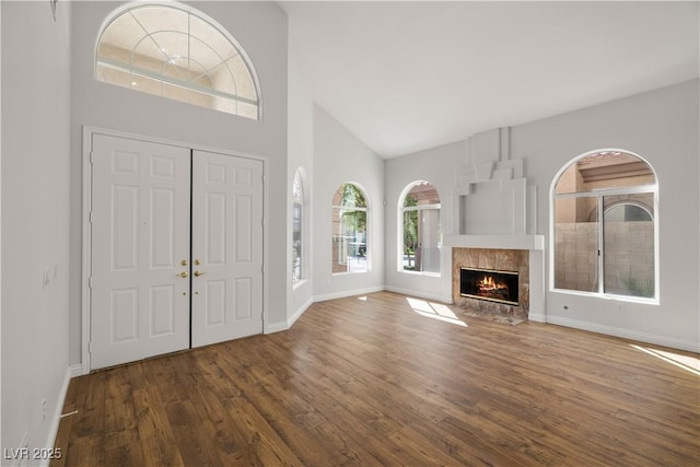 4607 El Camino Cabos Dr, Las Vegas, NV 89147 - entrance foyer with wood finished floors, high vaulted ceiling, baseboards, and a tiled fireplace