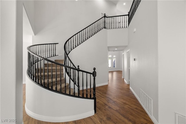 4607 El Camino Cabos Dr, Las Vegas, NV 89147 - staircase featuring wood finished floors, a towering ceiling, baseboards, and recessed lighting