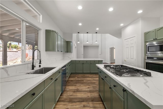 4607 El Camino Cabos Dr, Las Vegas, NV 89147 - kitchen featuring green cabinets, appliances with stainless steel finishes, a sink, dark wood-style floors, and recessed lighting
