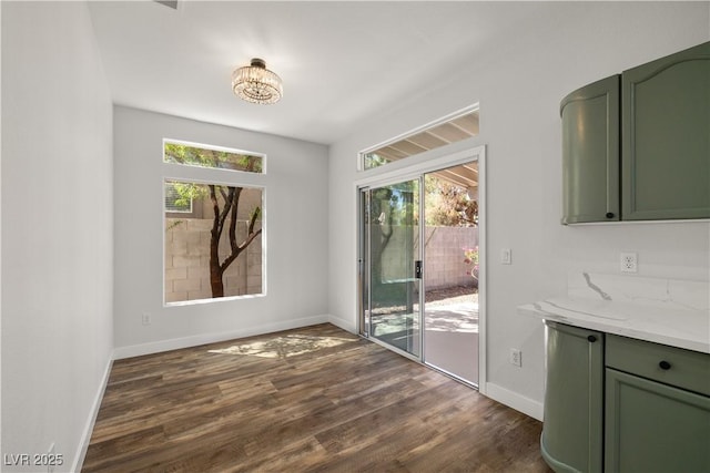 4607 El Camino Cabos Dr, Las Vegas, NV 89147 - unfurnished dining area featuring dark wood-style floors and baseboards