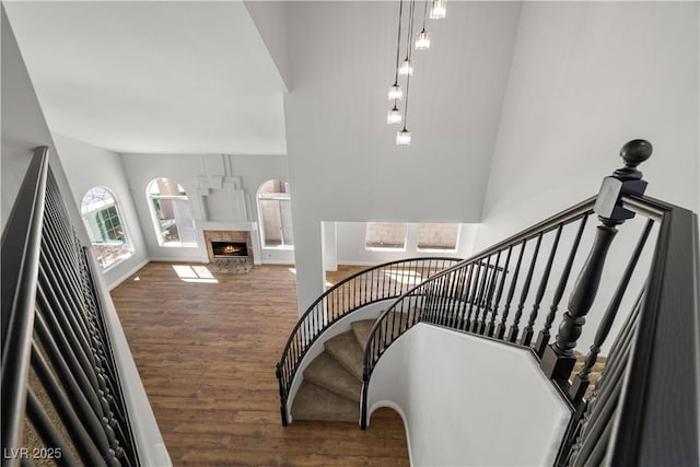 4607 El Camino Cabos Dr, Las Vegas, NV 89147 - staircase with wood finished floors and a warm lit fireplace