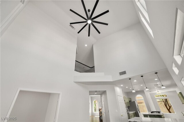 4607 El Camino Cabos Dr, Las Vegas, NV 89147 - detailed view of recessed lighting, light countertops, a kitchen island, pendant lighting, and arched walkways