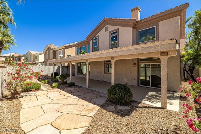 4607 El Camino Cabos Dr, Las Vegas, NV 89147 - rear view of property featuring a chimney, stucco siding, a patio, and fence