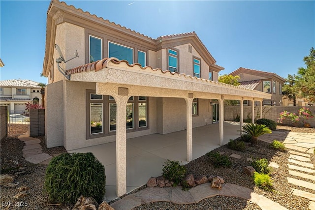 4607 El Camino Cabos Dr, Las Vegas, NV 89147 - back of house featuring stucco siding, a patio, a tiled roof, and fence