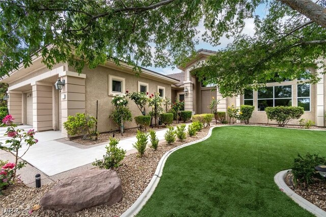 801 Aquitaine Ct, Las Vegas, NV 89145 - view of front of home featuring a front yard, stucco siding, and a garage
