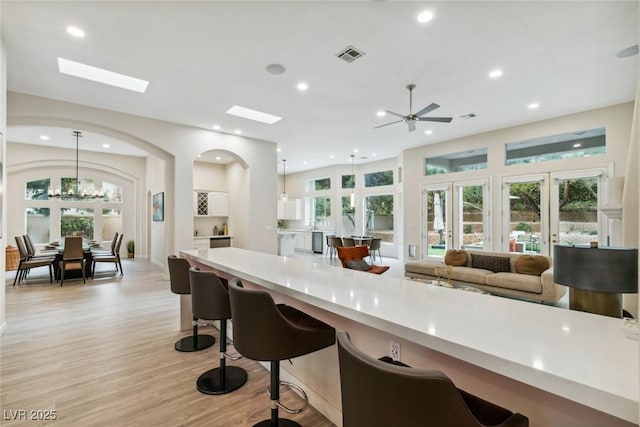 801 Aquitaine Ct, Las Vegas, NV 89145 - kitchen with light countertops, healthy amount of natural light, light wood-type flooring, and recessed lighting