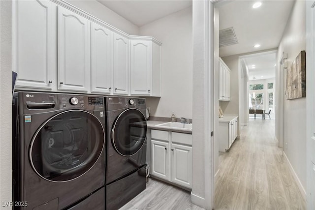 801 Aquitaine Ct, Las Vegas, NV 89145 - laundry area featuring light wood finished floors, cabinet space, separate washer and dryer, and recessed lighting