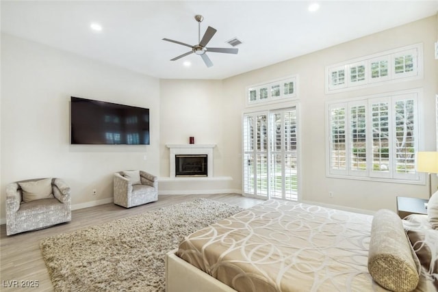 801 Aquitaine Ct, Las Vegas, NV 89145 - bedroom with wood finished floors, recessed lighting, a glass covered fireplace, a ceiling fan, and access to outside