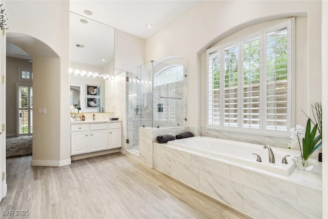 801 Aquitaine Ct, Las Vegas, NV 89145 - bathroom with vanity, a bath, a shower stall, and wood finished floors
