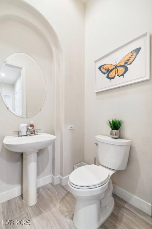 801 Aquitaine Ct, Las Vegas, NV 89145 - bathroom featuring baseboards and wood finished floors
