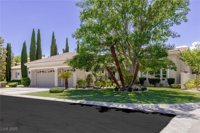 801 Aquitaine Ct, Las Vegas, NV 89145 - view of front of house with a garage, driveway, a front lawn, and stucco siding