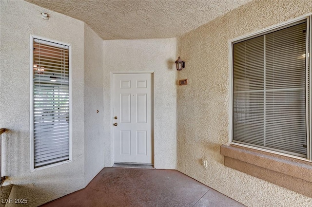 entrance to property featuring stucco siding