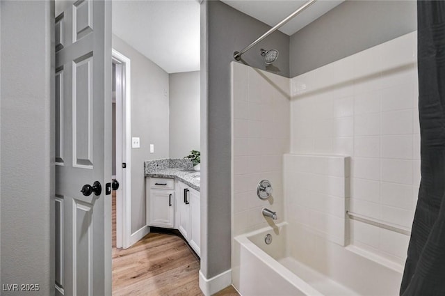 full bath featuring wood finished floors, tub / shower combination, and vanity