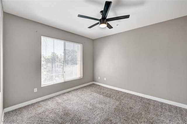 unfurnished room featuring carpet floors, a ceiling fan, and baseboards