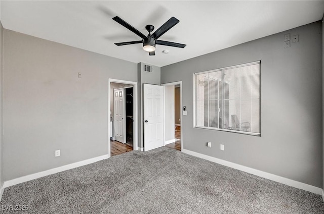 unfurnished bedroom with carpet, baseboards, and ceiling fan