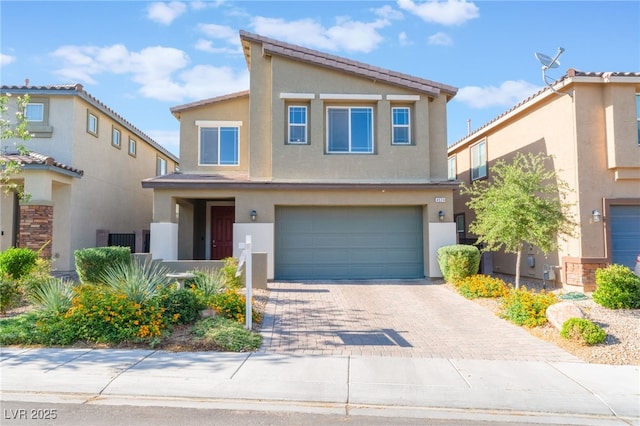 4524 Stardusk Falls Ave, North Las Vegas, NV 89084 - view of front of house with stucco siding, an attached garage, and decorative driveway