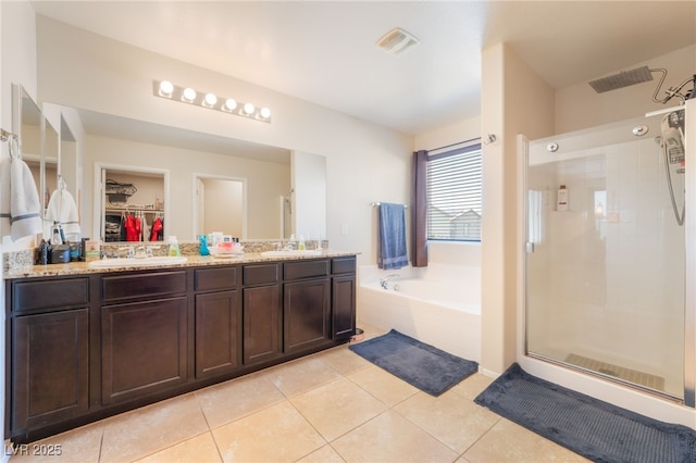 4524 Stardusk Falls Ave, North Las Vegas, NV 89084 - bathroom with a shower stall, a garden tub, double vanity, tile patterned floors, and a spacious closet