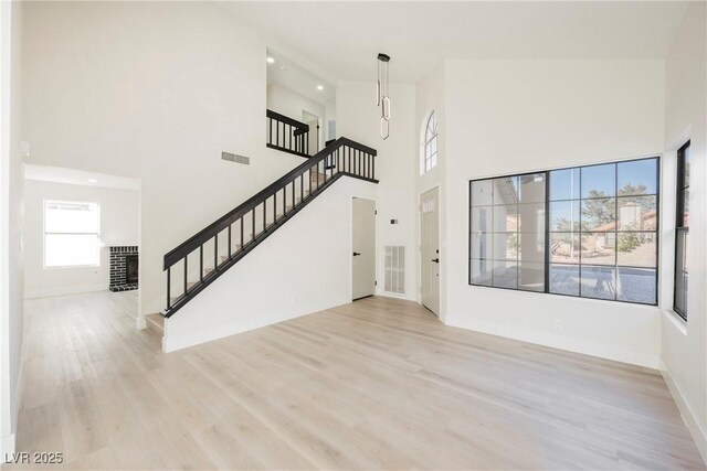 4669 Winfield Dr, Las Vegas, NV 89147 - entryway featuring stairs, light wood-style floors, baseboards, a high ceiling, and recessed lighting