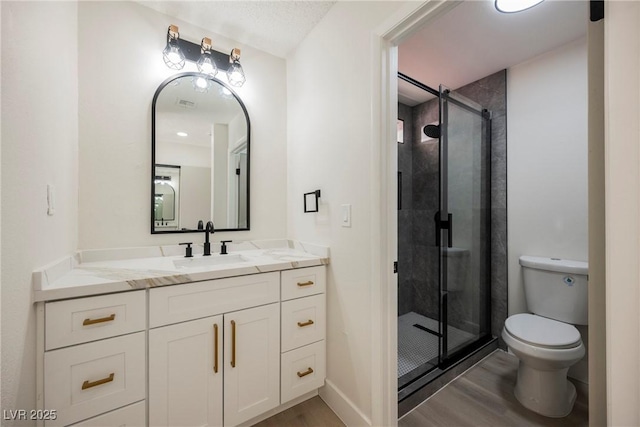 4669 Winfield Dr, Las Vegas, NV 89147 - full bathroom with wood finished floors, toilet, a shower stall, and vanity