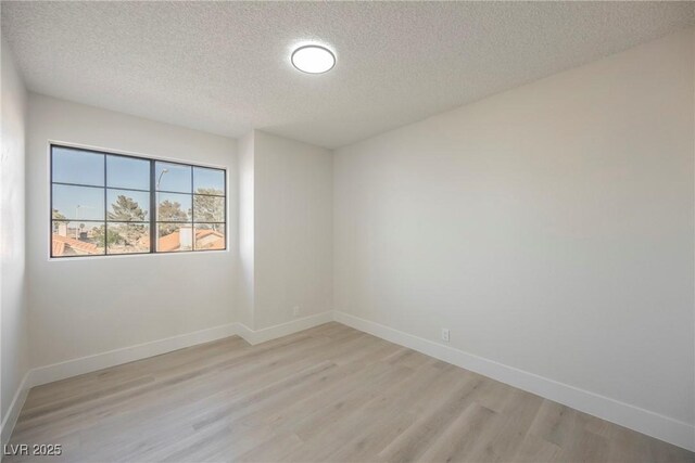 4669 Winfield Dr, Las Vegas, NV 89147 - empty room featuring a textured ceiling, light wood-type flooring, and baseboards