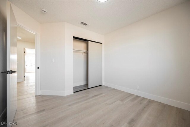 4669 Winfield Dr, Las Vegas, NV 89147 - unfurnished bedroom with light wood finished floors, baseboards, and a closet
