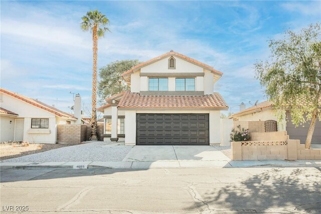 4669 Winfield Dr, Las Vegas, NV 89147 - mediterranean / spanish house featuring concrete driveway, an attached garage, stucco siding, fence, and a tile roof
