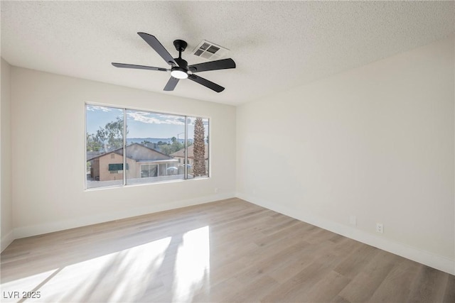 4669 Winfield Dr, Las Vegas, NV 89147 - spare room with light wood-type flooring, a textured ceiling, a ceiling fan, and baseboards