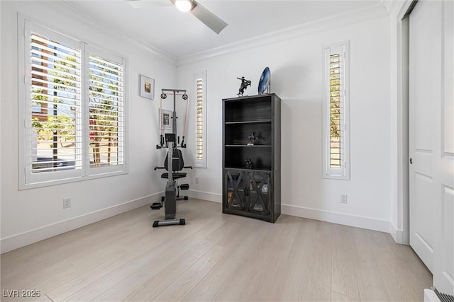 workout room featuring a ceiling fan, light wood-style flooring, ornamental molding, and baseboards