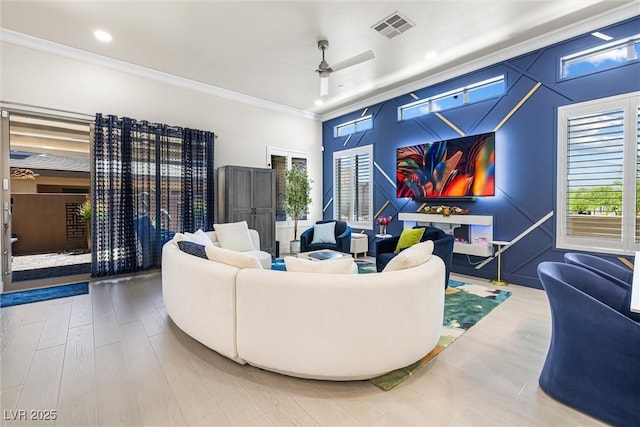 living area featuring a ceiling fan, crown molding, and recessed lighting
