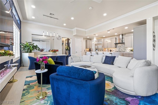 living room featuring recessed lighting and crown molding