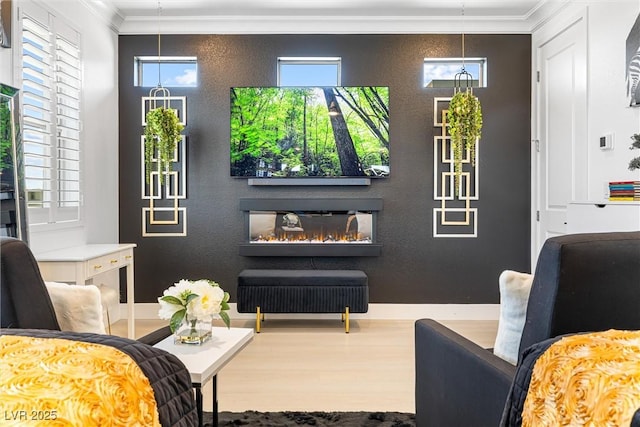 interior space featuring ornamental molding, wood finished floors, and a glass covered fireplace