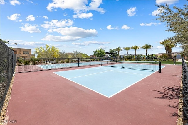 view of tennis court with fence