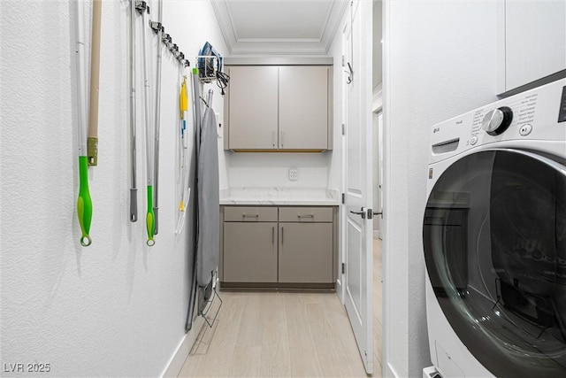 clothes washing area featuring washer / clothes dryer and crown molding