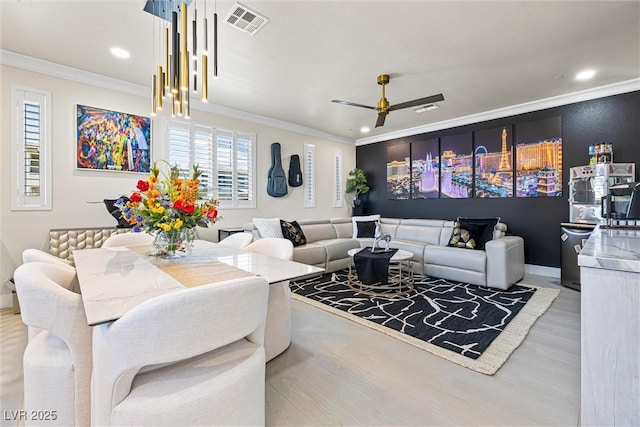 living area featuring crown molding, light wood-style floors, a ceiling fan, recessed lighting, and baseboards