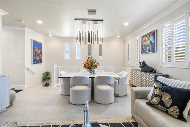 dining space featuring recessed lighting, ornamental molding, light wood-type flooring, and baseboards