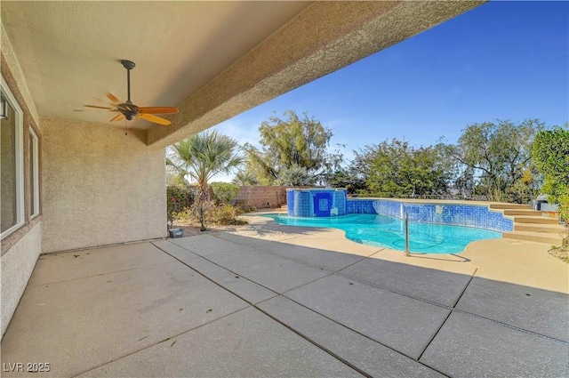view of swimming pool with ceiling fan, a patio area, and a fenced backyard