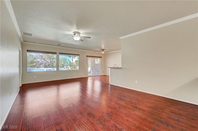 empty room with a ceiling fan, wood finished floors, ornamental molding, and baseboards
