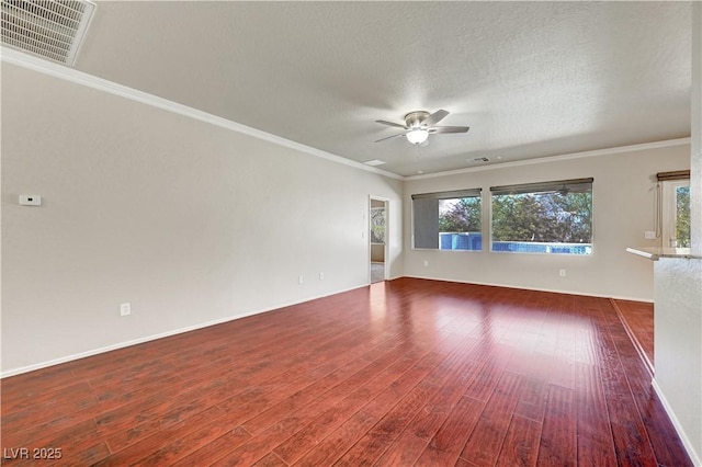 empty room featuring wood finished floors, a ceiling fan, plenty of natural light, crown molding, and baseboards