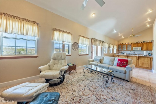 3640 E Vineyard Dr, Pahrump, NV 89048 - living area with ceiling fan, healthy amount of natural light, light tile patterned floors, baseboards, and vaulted ceiling