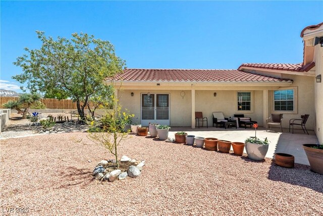 3640 E Vineyard Dr, Pahrump, NV 89048 - rear view of house with a tiled roof, stucco siding, and a patio