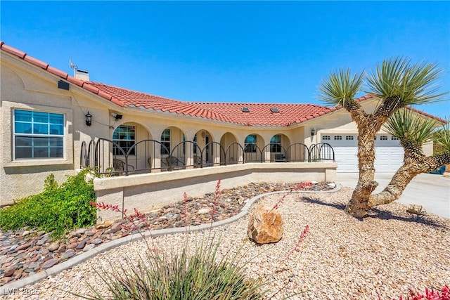 3640 E Vineyard Dr, Pahrump, NV 89048 - rear view of property with stucco siding, a garage, driveway, a chimney, and a tiled roof