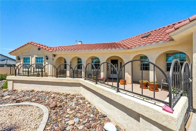 3640 E Vineyard Dr, Pahrump, NV 89048 - rear view of house featuring a tiled roof and stucco siding